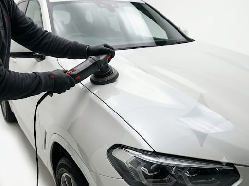 Dual-action rotary machine polishing on car bonnet for swirl elimination at Mithra Auto Hub